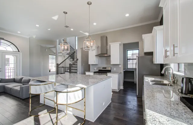 a kitchen with granite countertop a sink stainless steel appliances a counter space and cabinets