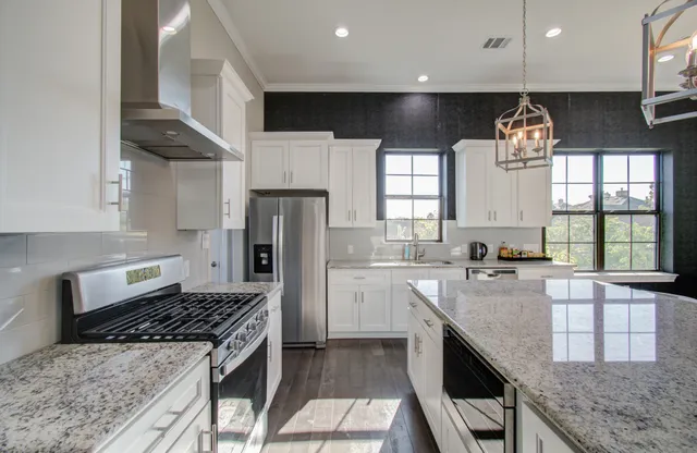 a living room with furniture chandelier and a rug