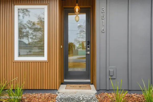 a view of a wooden door with a large window