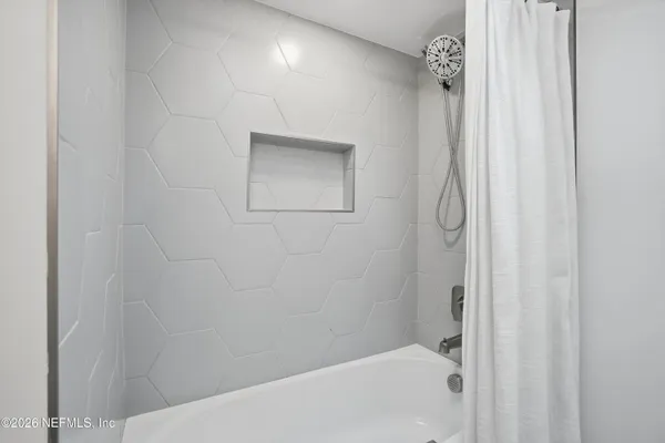 a bathroom with a bathtub and shower