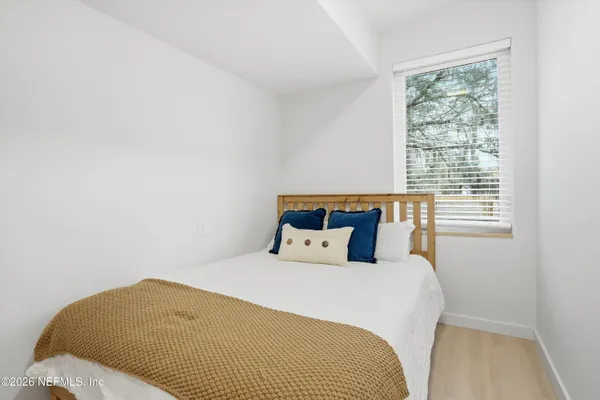 a bedroom with a bed and window