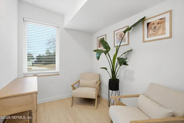 a view of living room with furniture and a potted plant