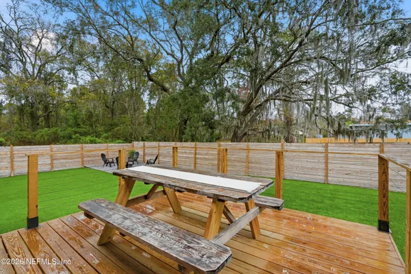 a view of a wooden deck and a yard