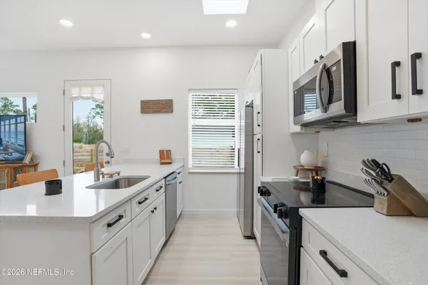a kitchen that has a sink and a stove in it