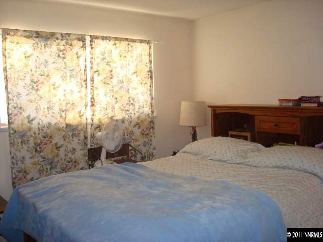 3445 West 7th Street Reno, NV 89503 - Photo 7 of 13 a bedroom with a bed and a window