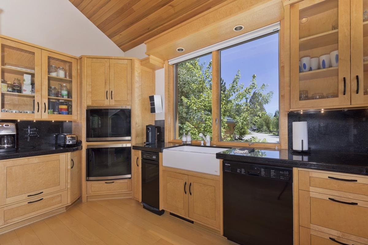 92 Garnet Street Mammoth Lakes, CA 93546 - Photo 13 of 50 Kitchen with black appliances, vaulted ceiling, wood ceiling, light wood-type flooring, and light brown cabinetry