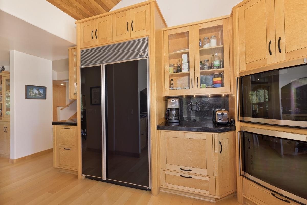 92 Garnet Street Mammoth Lakes, CA 93546 - Photo 14 of 50 Kitchen featuring paneled built in fridge, stainless steel microwave, dark countertops, light brown