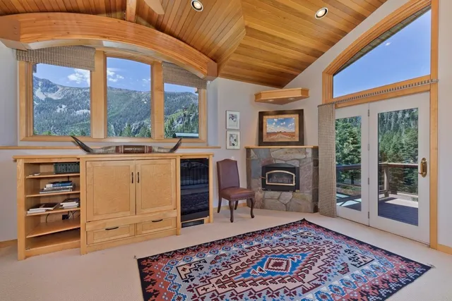 a view of an empty room with a fireplace and a window