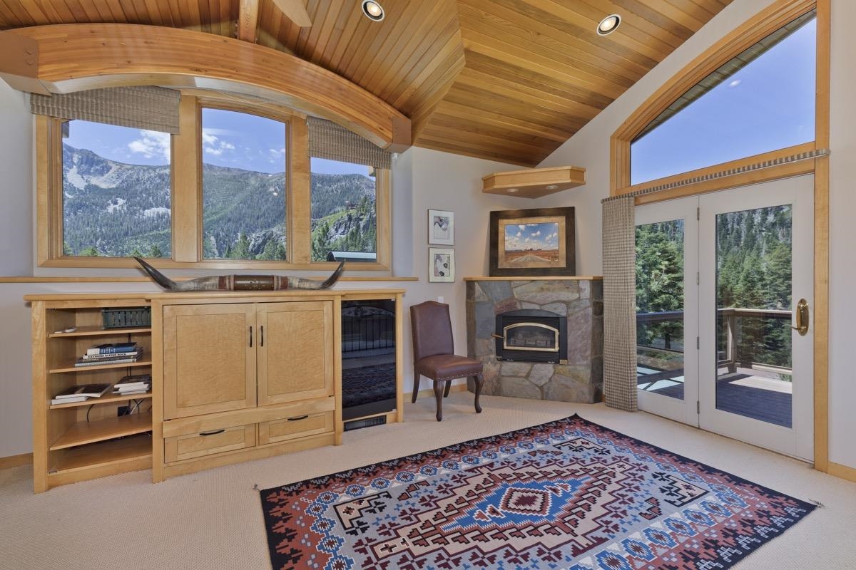 92 Garnet Street Mammoth Lakes, CA 93546 - Photo 19 of 50 Living area with wood ceiling, lofted ceiling, carpet flooring, and a stone fireplace