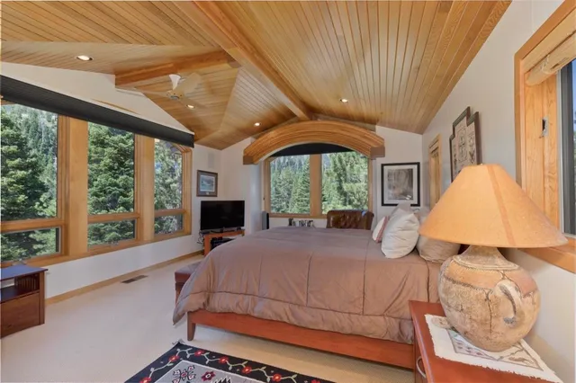 a bedroom with a large bed and a large window