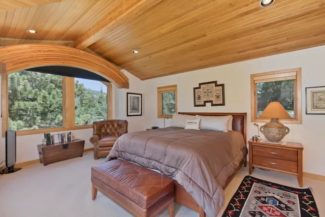 a bedroom with a bed couch and window