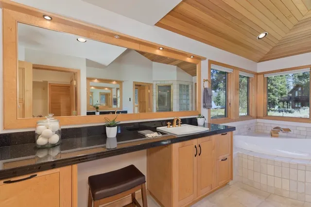 a large bathroom with a large tub and sink