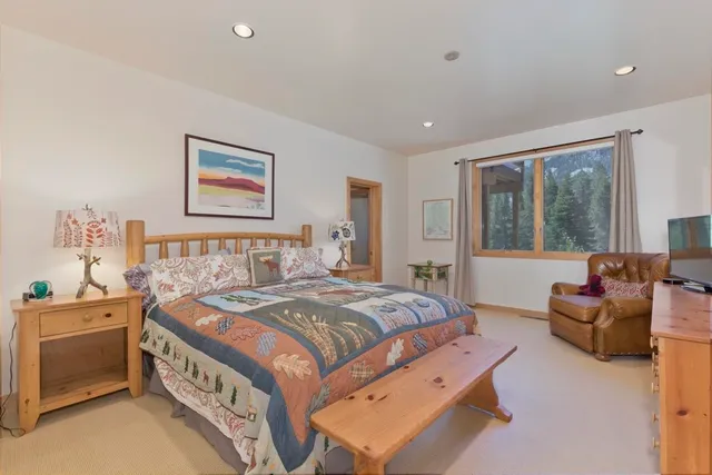 a bedroom with a bed and a chandelier