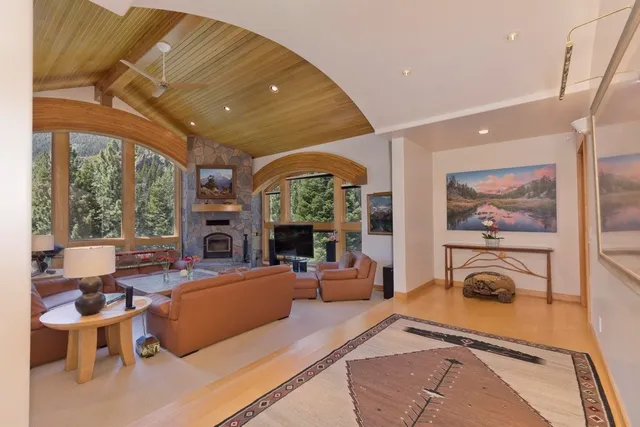a living room with furniture a fireplace and a large window