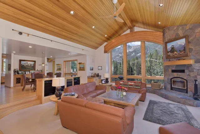 a living room with furniture a fireplace and a chandelier