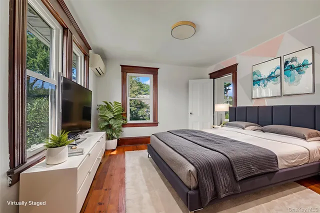 a bedroom with a large bed and a large window