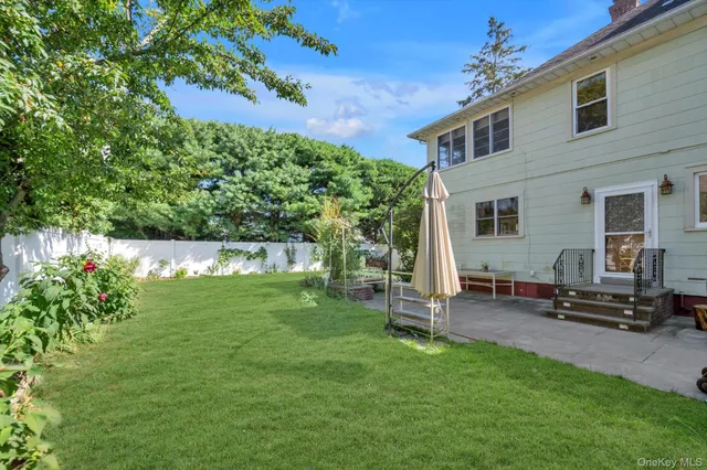 a backyard of a house with table and chairs