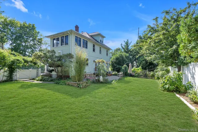 a view of a house with a yard and sitting area