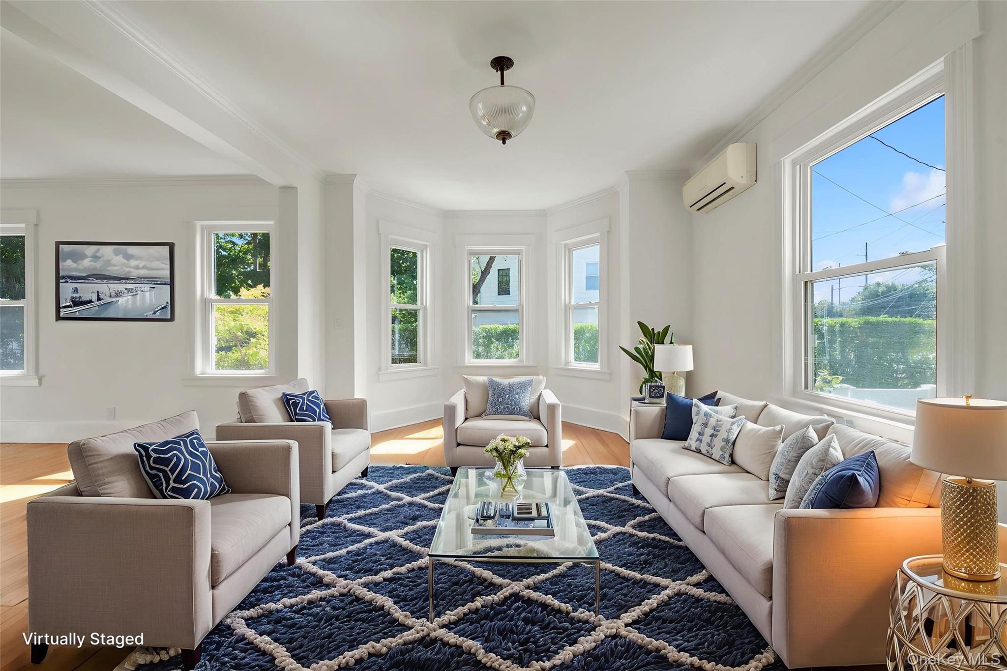182 Berry Hill Road Syosset, NY 11791 - Photo 4 of 24 Living area featuring plenty of natural light, light wood-style floors, ornamental molding, and a wall mounted AC