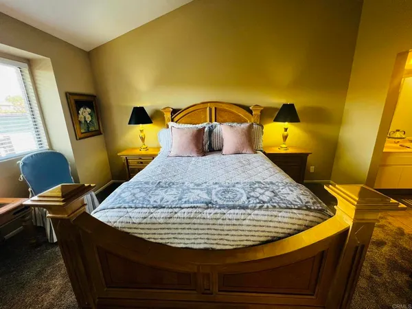 a en suite bathroom with a granite countertop sink and a mirror