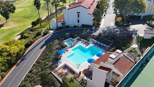 an aerial view of a house with a swimming pool