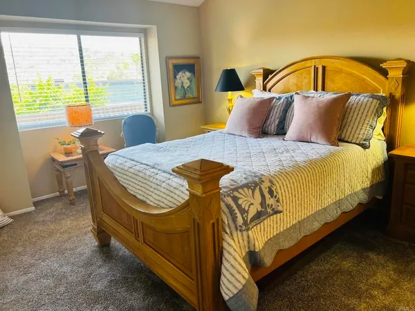 a bedroom with a bed and chair