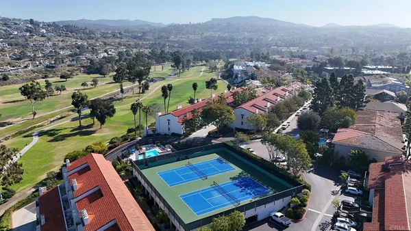 an aerial view of a residential houses with outdoor space