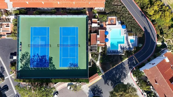an aerial view of a house with a yard basket ball court and outdoor seating