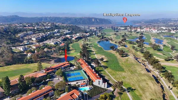 an aerial view of a houses with a swimming pool