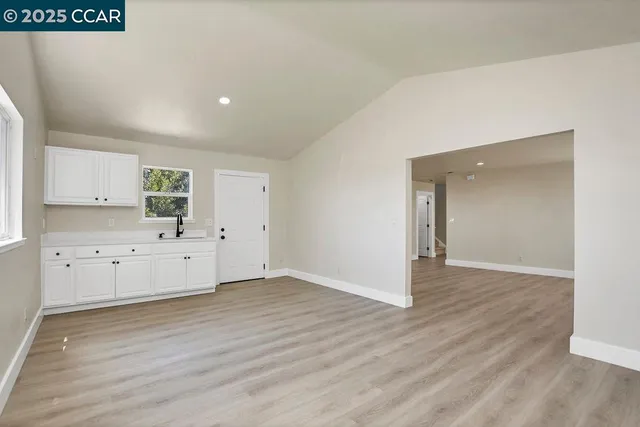 a big room with wooden floor and windows