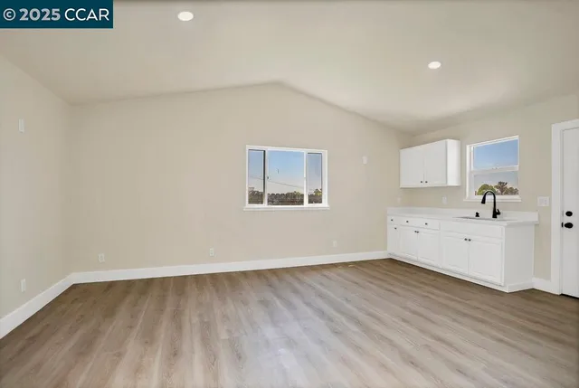 a view of an entryway with wooden floor