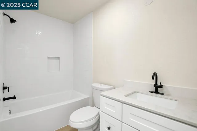 a bedroom with a large bed and a flat screen television