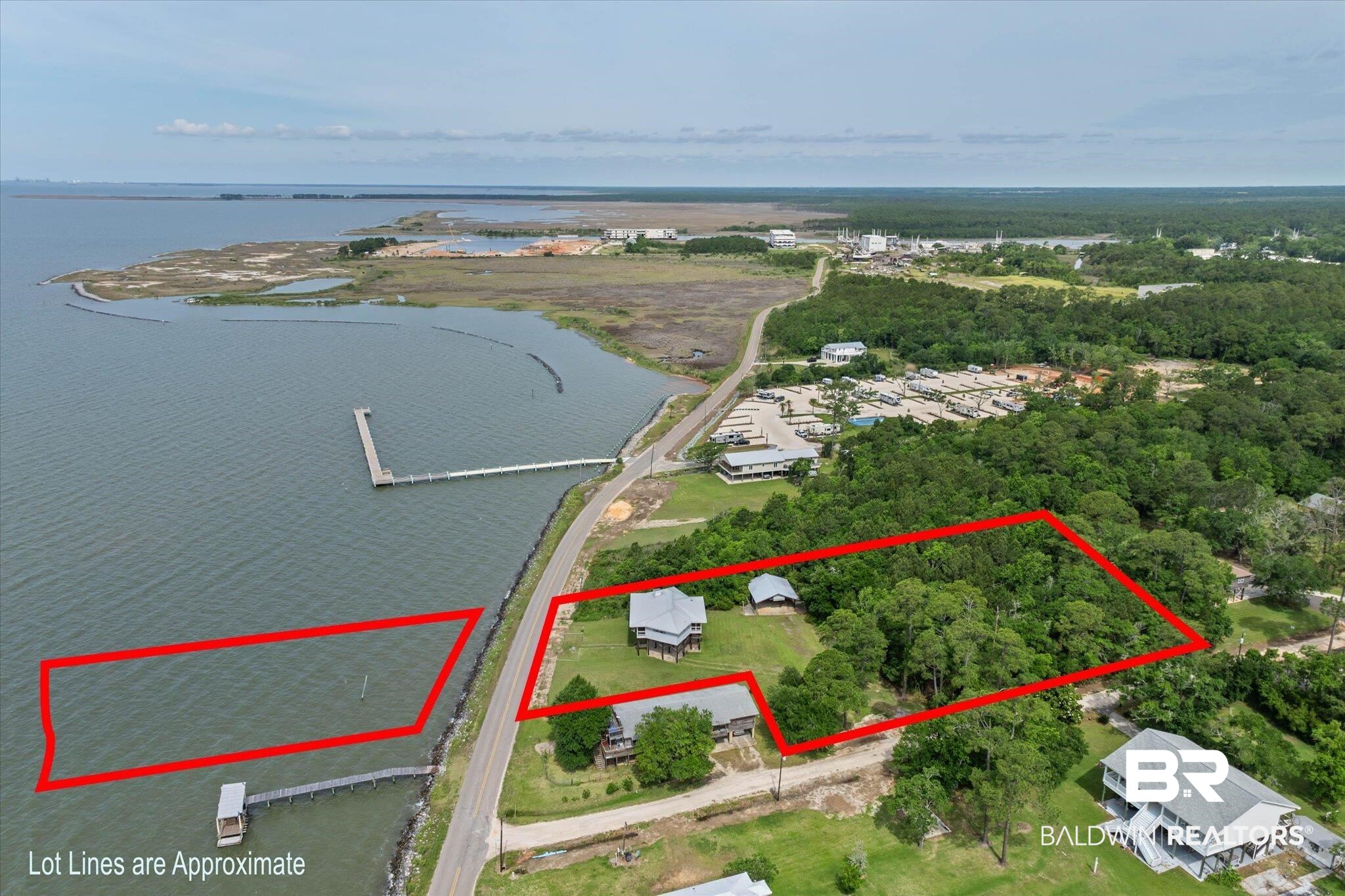 9100 Shell Belt Road Coden, AL 36523 - Photo 31 of 38 Expansive waterfront property featuring a substantial land parcel, established vegetation, an existing dock structure, and direct water frontage