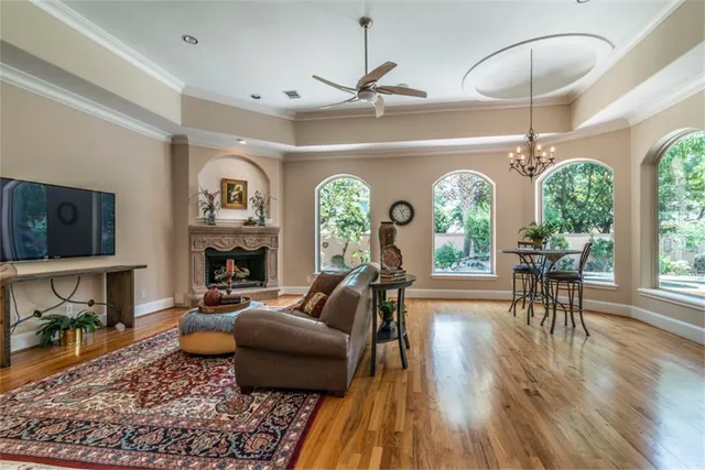 a living room with fireplace furniture and a wooden floor