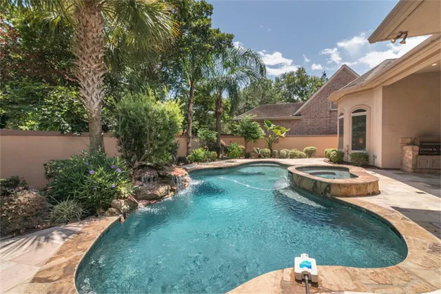 a swimming pool with outdoor seating and yard