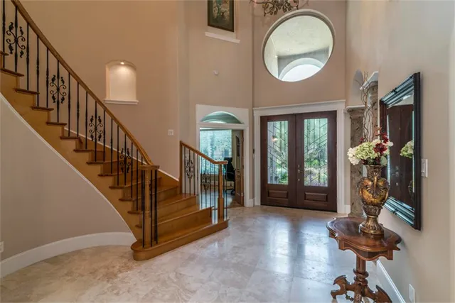 a view of an entryway with wooden floor and a livingroom view