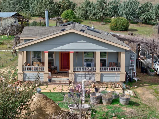 a backyard of a house with yard and outdoor seating