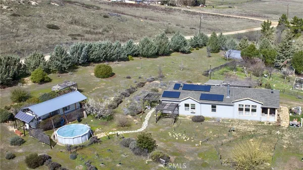 an aerial view of a house with a yard