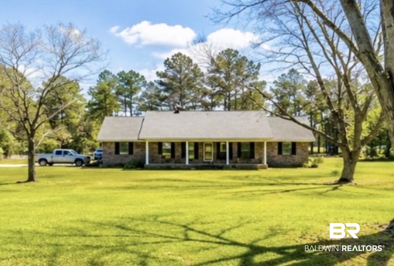 12092 Gantt Red Level Road Andalusia, AL 36421 - Photo 4 of 33 Ranch-style residence featuring a brick facade, covered front porch with white columns, and dark window shutters
