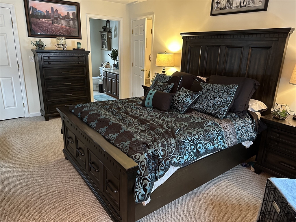 28 Ely Street Randolph, MA 02368 - Photo 12 of 28 a bed sitting in a bedroom next to a window