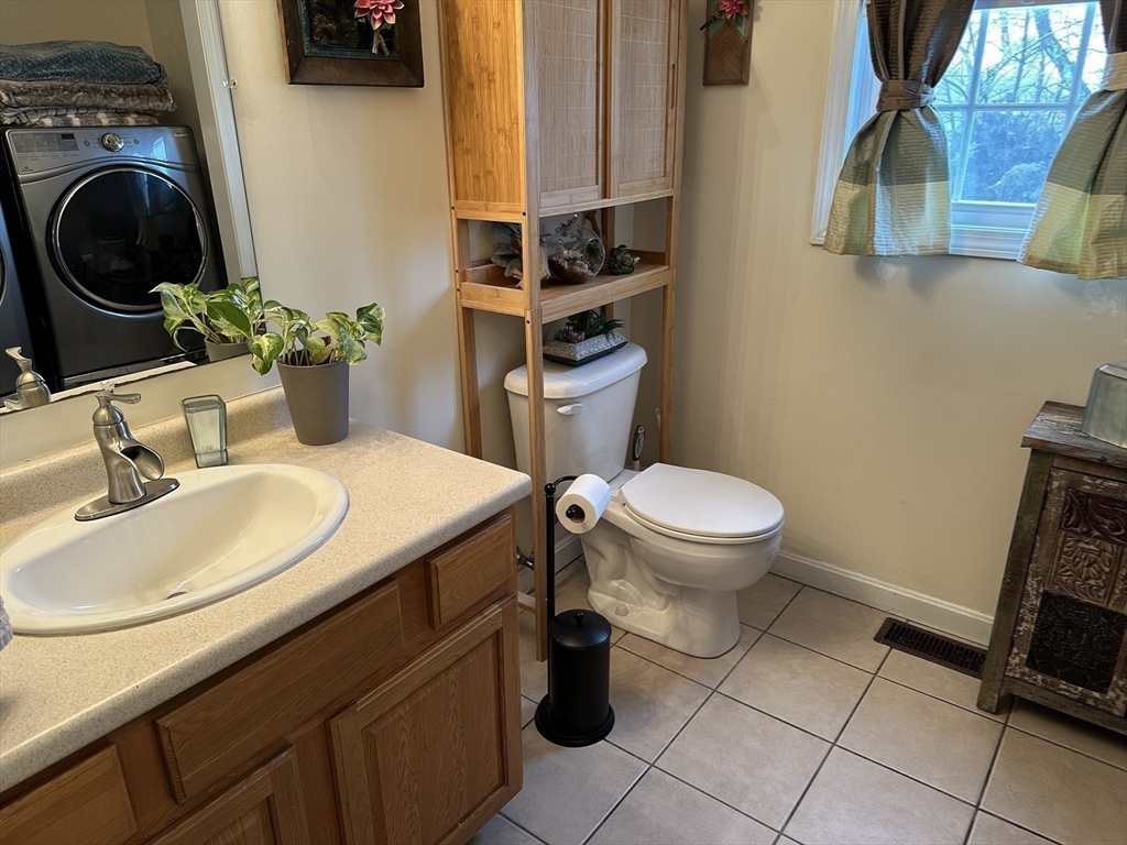 28 Ely Street Randolph, MA 02368 - Photo 17 of 28 a bathroom with a sink a toilet and a mirror
