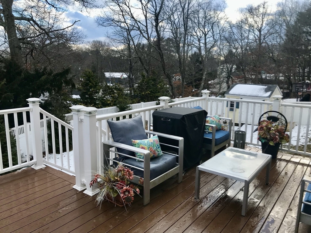 28 Ely Street Randolph, MA 02368 - Photo 24 of 28 a view of a deck with table and chairs a barbeque with wooden floor and fence