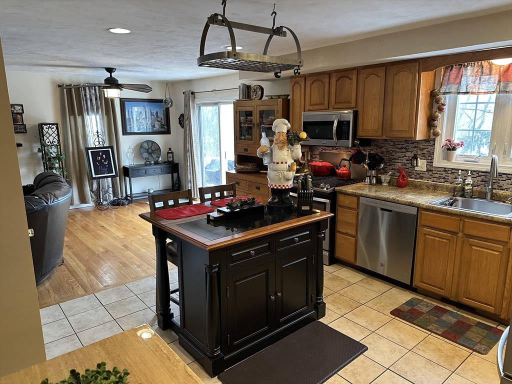 28 Ely Street Randolph, MA 02368 - Photo 3 of 28 a kitchen with a stove a sink dishwasher and a refrigerator