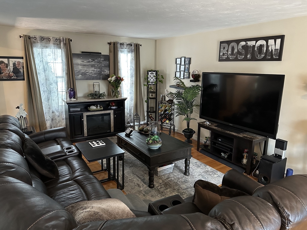 28 Ely Street Randolph, MA 02368 - Photo 7 of 28 a living room with furniture and a flat screen tv