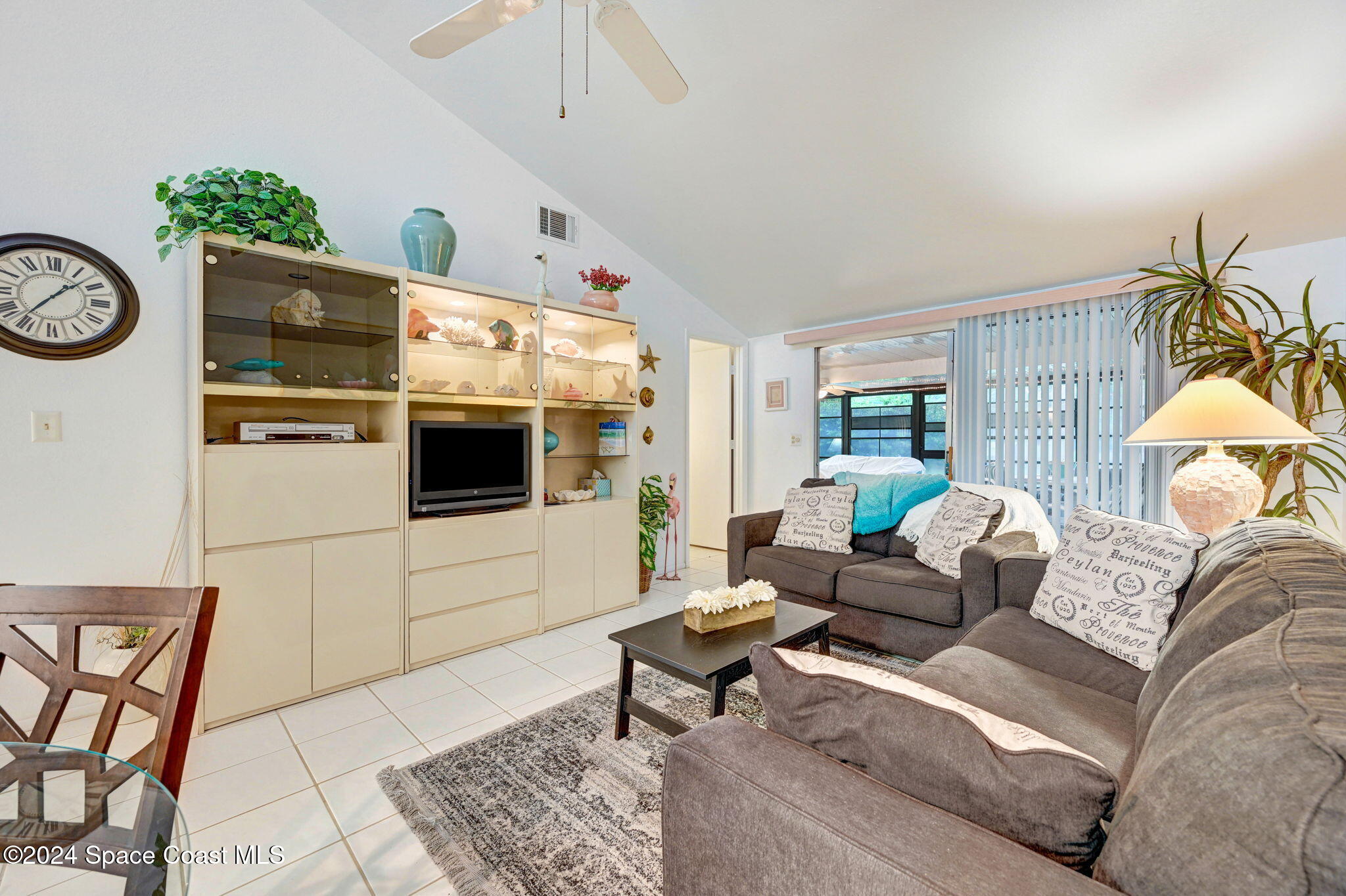 815 Brae Court Northeast Palm Bay, FL 32905 - Photo 12 of 21 a living room with furniture and a flat screen tv