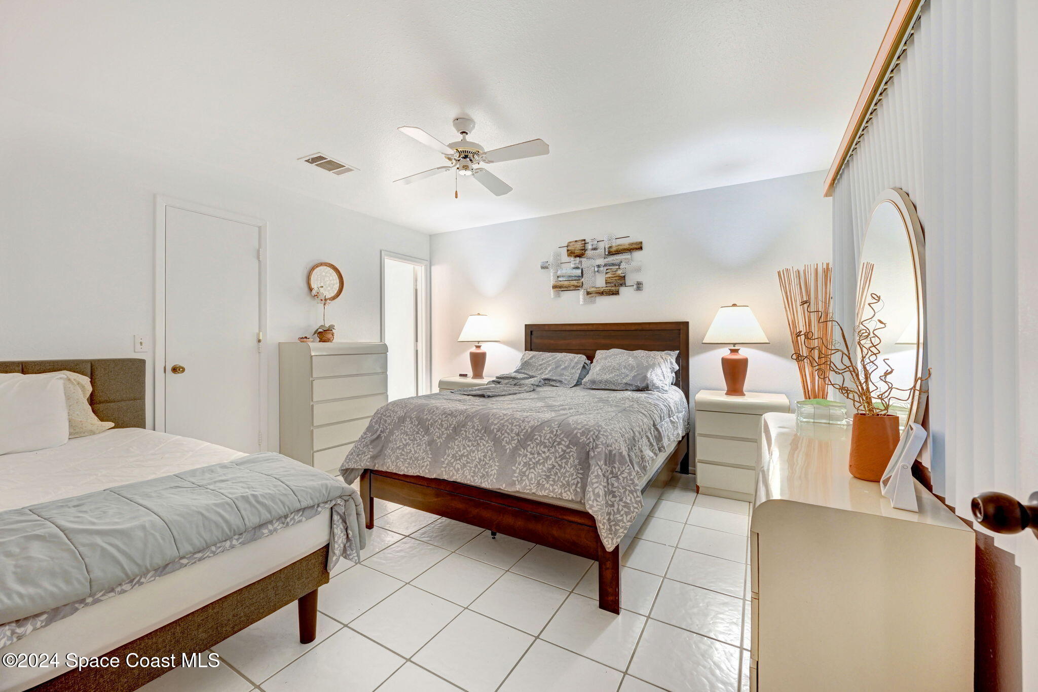 815 Brae Court Northeast Palm Bay, FL 32905 - Photo 14 of 21 a bedroom with a bed and a chandelier