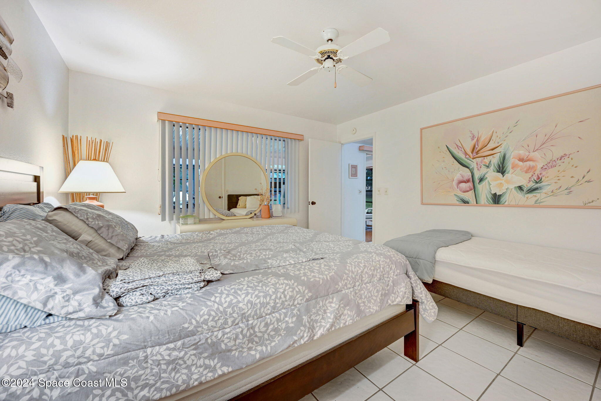 815 Brae Court Northeast Palm Bay, FL 32905 - Photo 15 of 21 a bedroom with a large bed and a painting on the wall