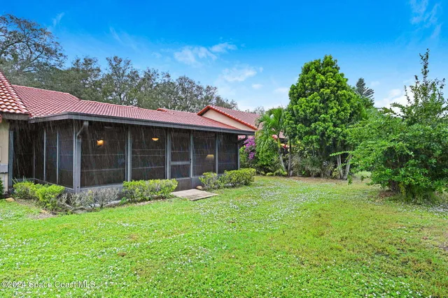 a view of a house with yard and a garden