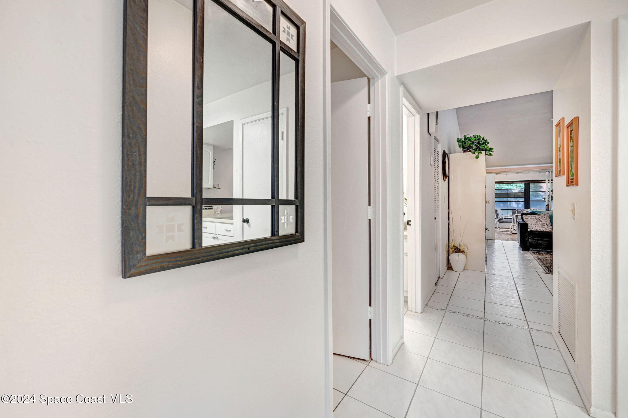 815 Brae Court Northeast Palm Bay, FL 32905 - Photo 3 of 21 a view of a hallway with wooden floor and entryway