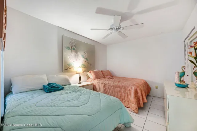 a bedroom with a bed and painting on the wall